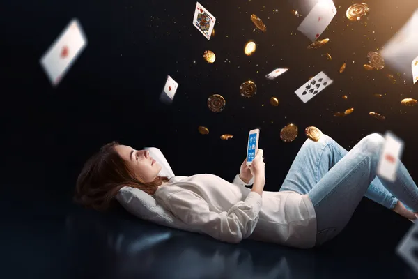 A young woman relaxing with her phone while dynamic casino elements float around her, illustrating the smooth mobile experience offered by the 83JLPH app.