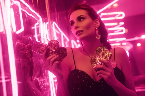 A glamorous woman holding casino chips in a neon-lit environment, representing the premium online casino atmosphere of 83JLPH.