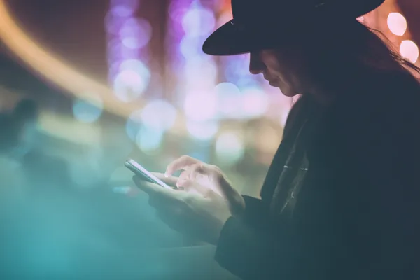 A confident dealer surrounded by casino chips inviting players to access their 83JLPH account, reflecting quick and easy login options.